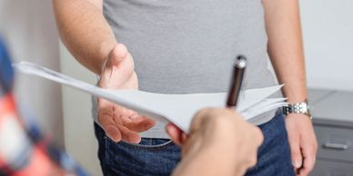 Image shows a process server handling legal documents.
