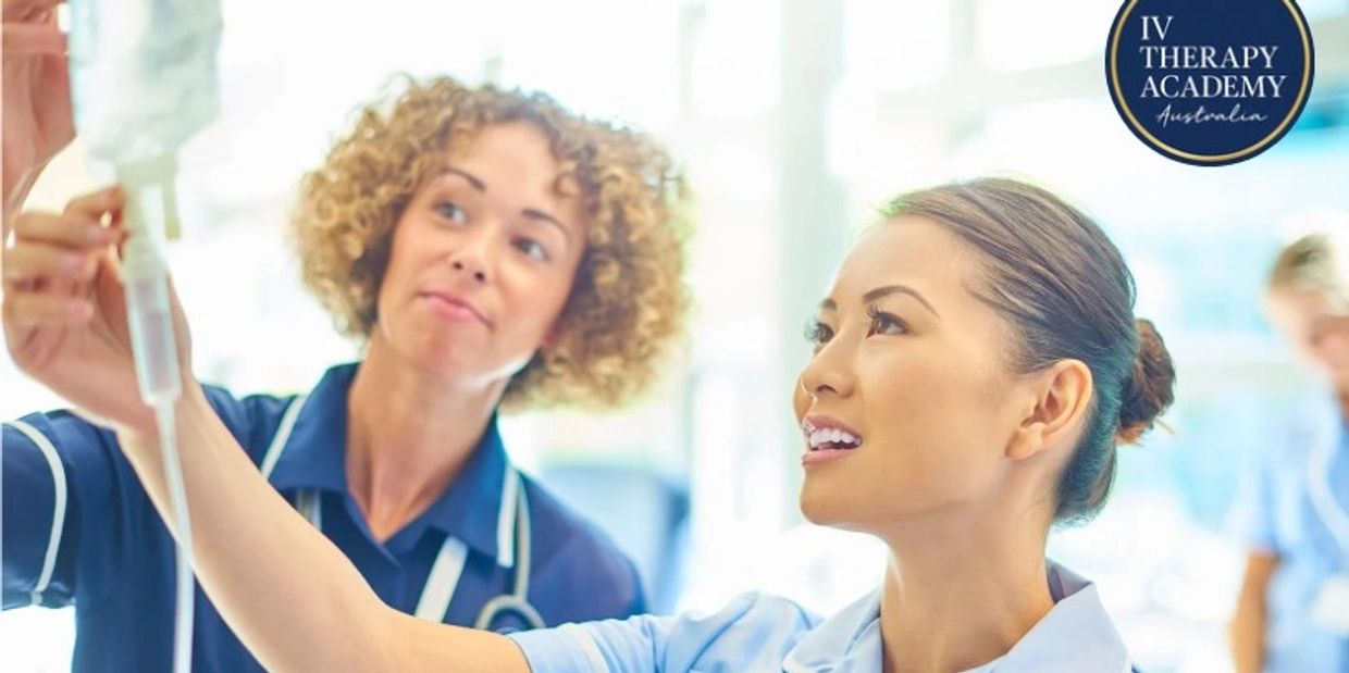 Two nurses adjusting an IV drip in a clinical setting.
