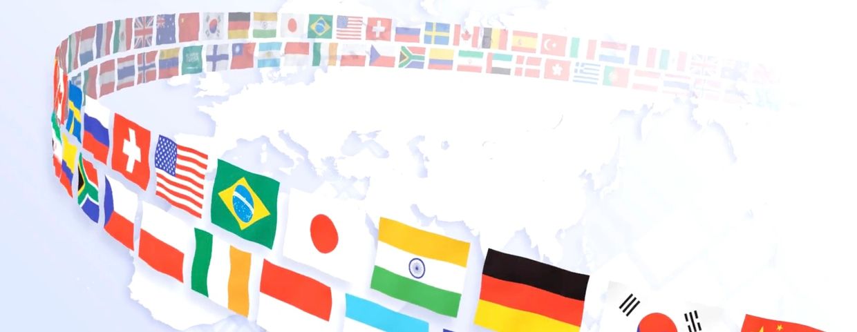 A curved line of various international flags over a faint world map background.