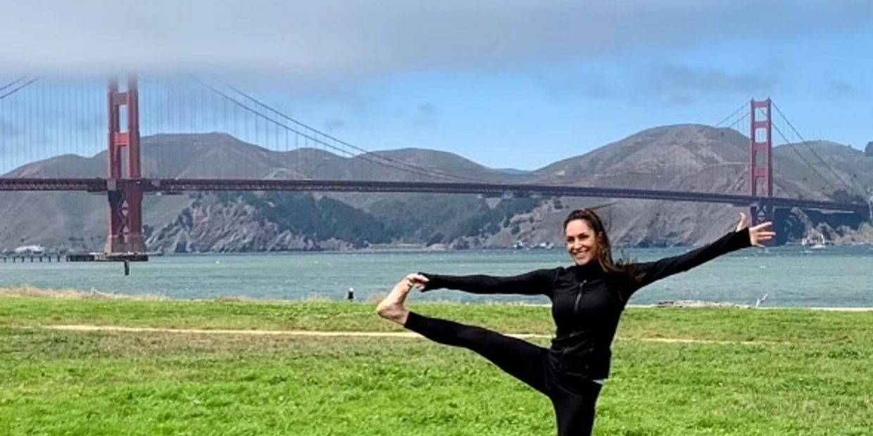 Coach M living her best life and doing yoga with the golden gate bridge in the background.