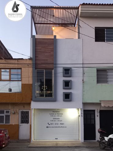 Modern three-story commercial and residential building with a clean facade.