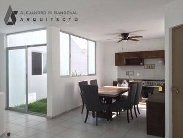 Modern dining area with glass doors and minimalist kitchen design.