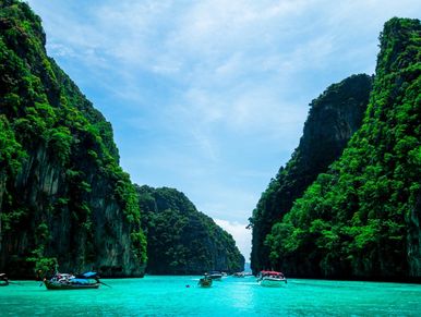 A beautiful place covered with long mountains and some boats