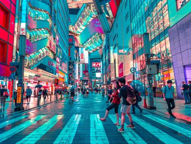 People walking in between the street filled with lights