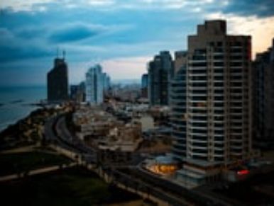 Top view of a city with night lights and long buildings