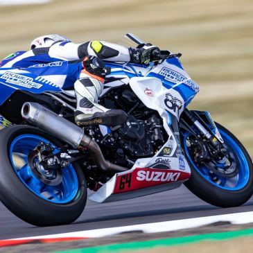 Motorcyclist racing on a Suzuki sportbike.