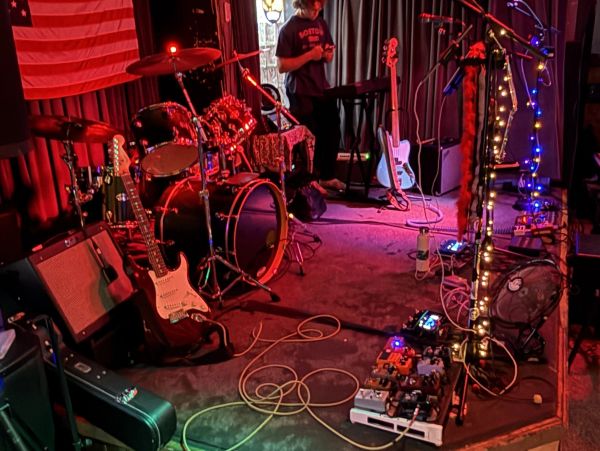 A dimly lit stage setup with musical instruments and equipment.