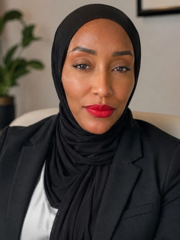 Confident woman in a black hijab and red lipstick.