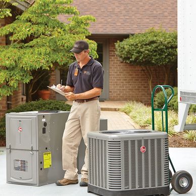 Technician inspecting HVAC equipment and taking notes outside a house.