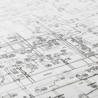 Close-up of detailed architectural blueprints with measurements and room labels.