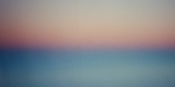 Soft gradient sky blending blue, pink, and orange hues.