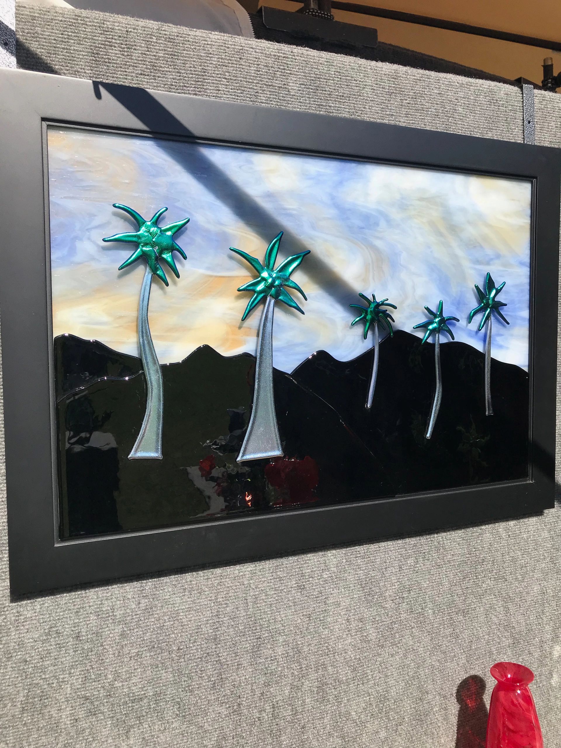 Black silhouette hills with beautiful protruding palm trees and a whistful sky. Approx. 30"x24"