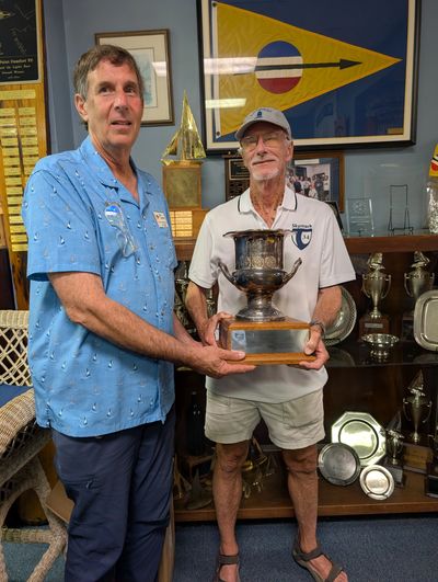 OPCYC Commodore Kennith Damon returning the Tri-Service Cup to NNSA Racing Captain Tim Dull in the O