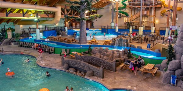 Aerial image of indoor waterpark with activity pool, lazy river, wave pool and waterslides