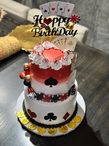 A casino-themed birthday cake with playing cards and poker chips.