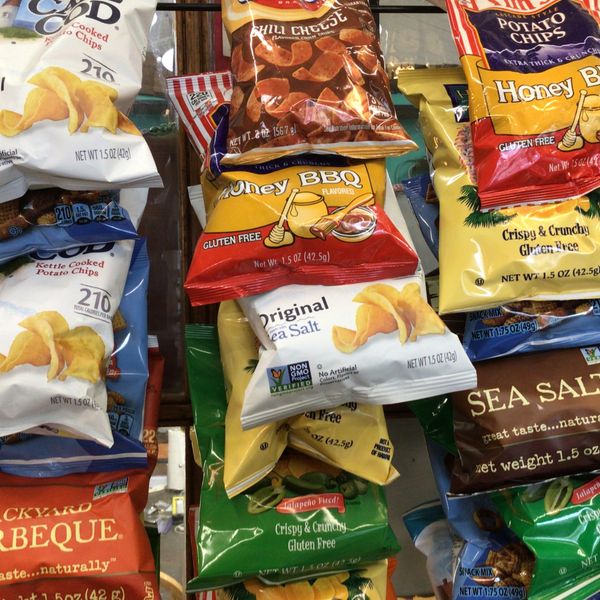 Various flavors of potato chips displayed in colorful bags.