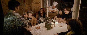 Group of people dining together in a cozy setting.