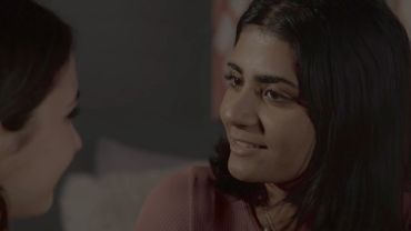 Two women engaged in a close conversation.