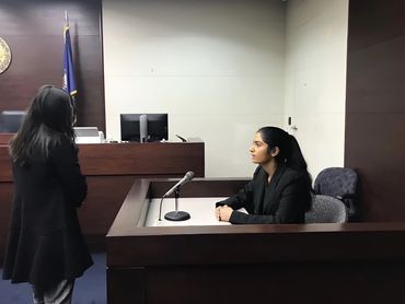 Woman testifying in a courtroom.