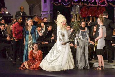 Theater group in costumes during a performance.