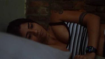 Person sleeping wearing a striped top and smartwatch.