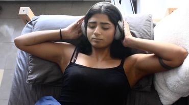 Woman relaxing with headphones on.