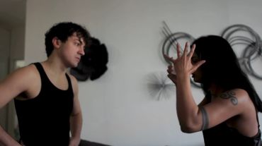 Two people arguing intensely indoors.