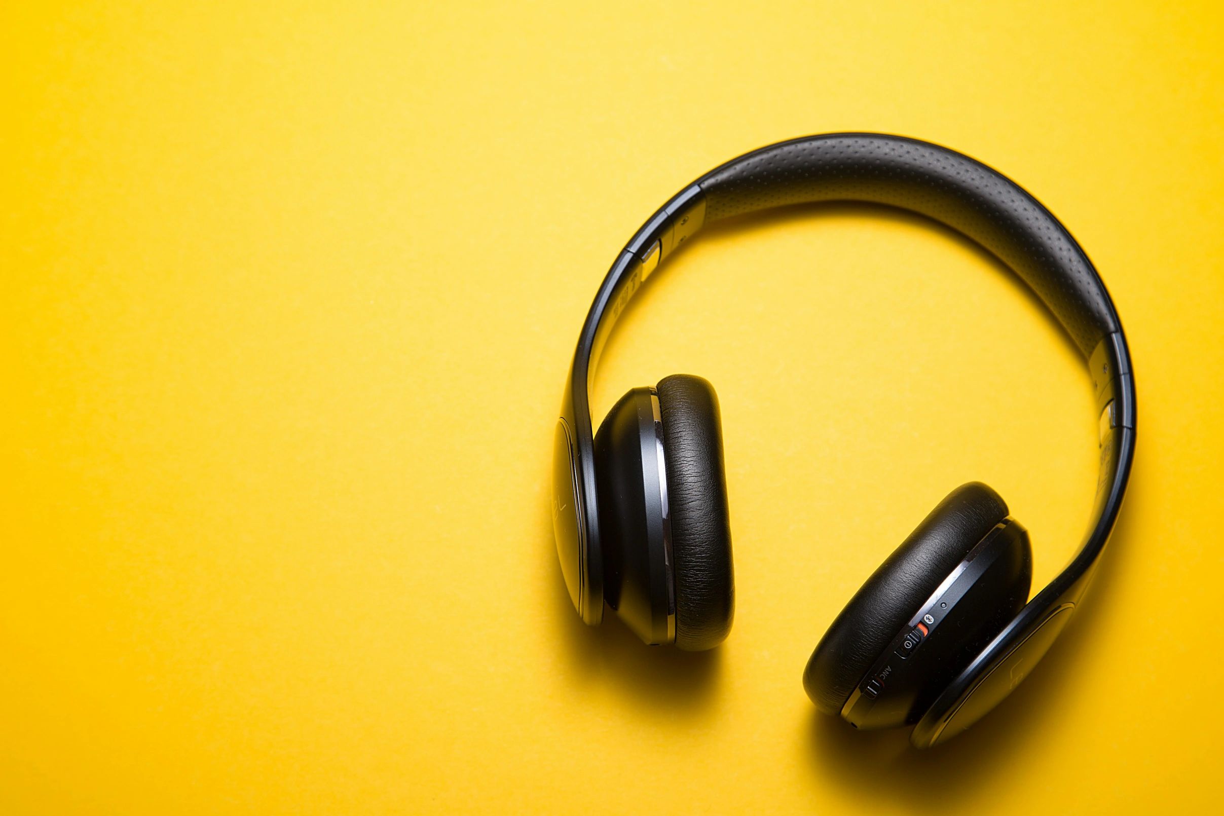 Black headphones on a yellow background