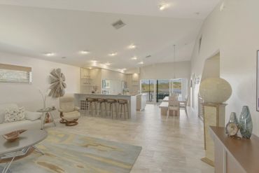 Spacious open-concept living area with modern furniture and natural light.