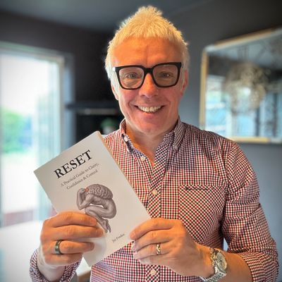 Jay Forden holding a copy of his book RESET