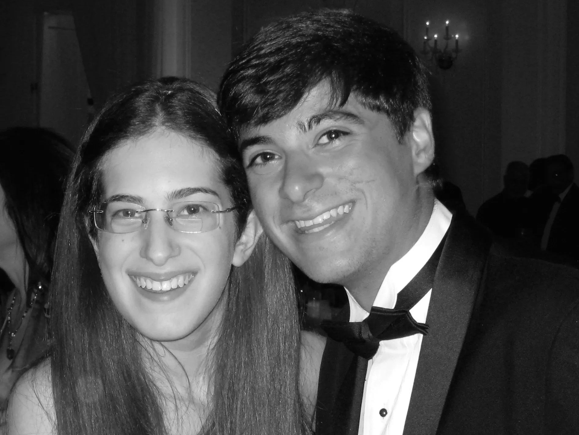 Smiling couple posing closely at a formal event.