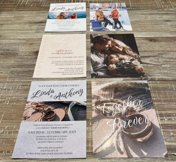 Wedding invitations and romantic photos arranged on a wooden surface.