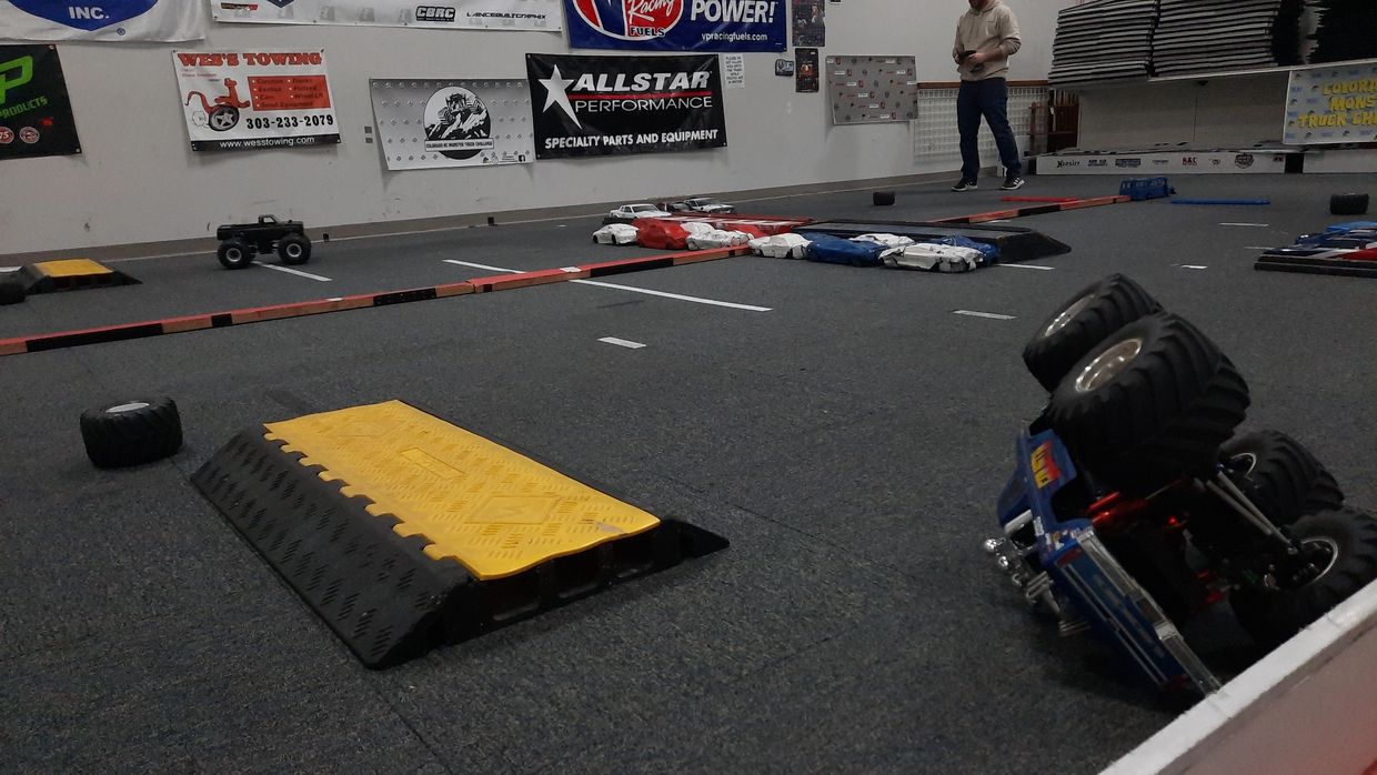An overturned RC in the foreground waits as the opponent finishes the race
