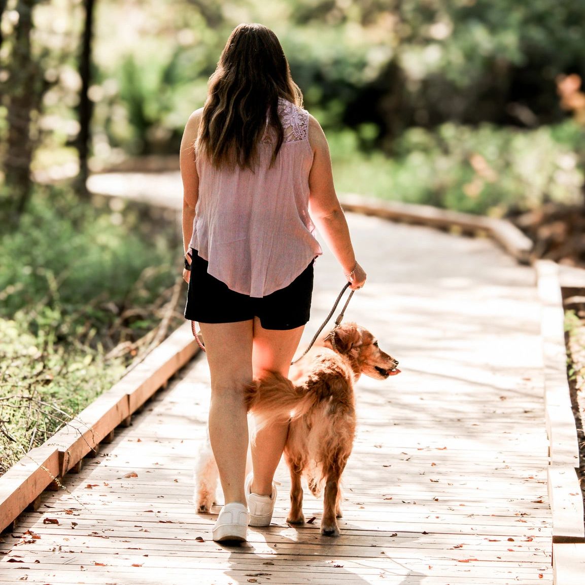 Rebecca the owner walking her two dogs. Photo by: LeeAnna Davis Photography