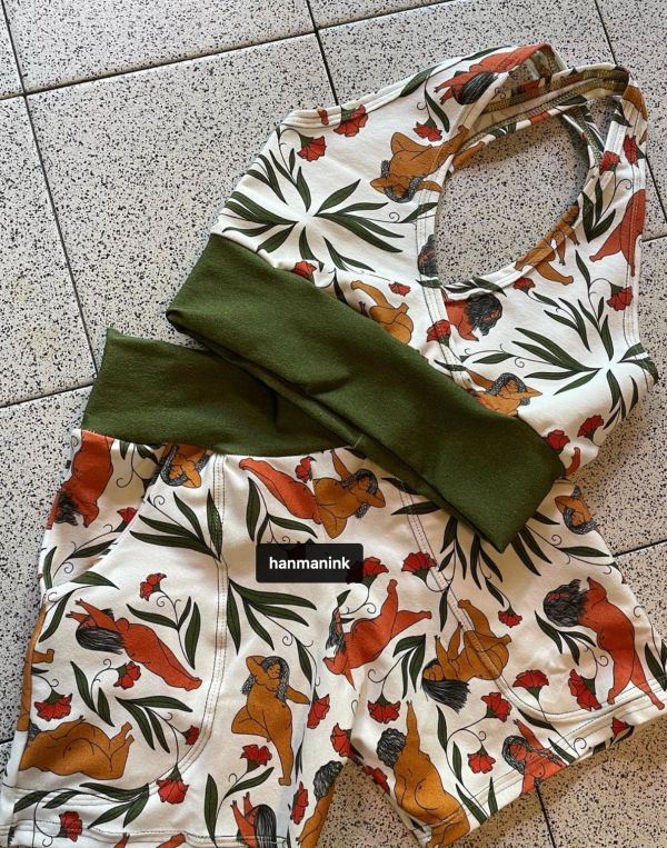 Floral and figure print workout set with olive green accents on tiled floor.