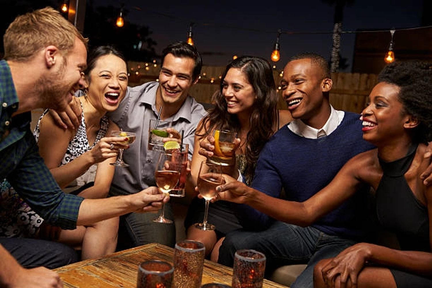 Group of people having fun and enjoying wine at a restaurant