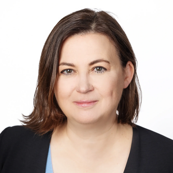 Professional headshot of a woman with brown hair and a black blazer.