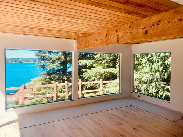 Wood ceiling and beam big glass windows and smooth drywall finish 