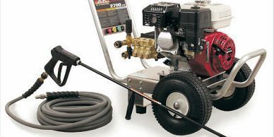 A gas-powered pressure washer with hose and spray gun.