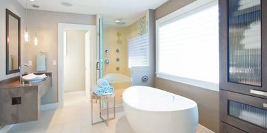 Modern bathroom with freestanding tub and glass shower enclosure.
