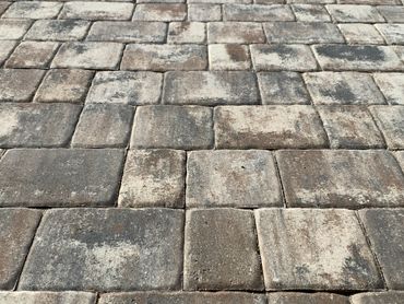 Close-up of weathered stone pavers on a patio or walkway.