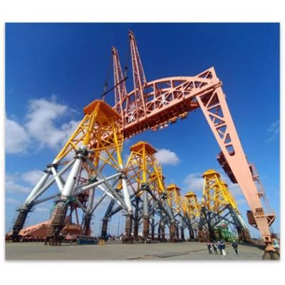 Large industrial crane structure under a bright blue sky.