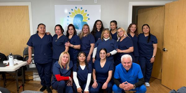 Group of healthcare professionals posing together in a room.