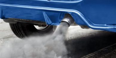A car with smoke coming out of the exhaust 