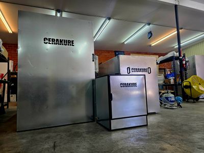 Cerakure branded industrial ovens in a workshop setting.