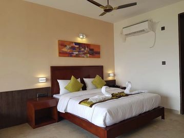 Comfortable AC room with clean bed, attached bathroom, TV and free Wi-Fi. Perfect for couples and sm