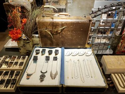 A suitcase featuring locally made jewelry from the gift shop Trunk Nouveau in Aurora