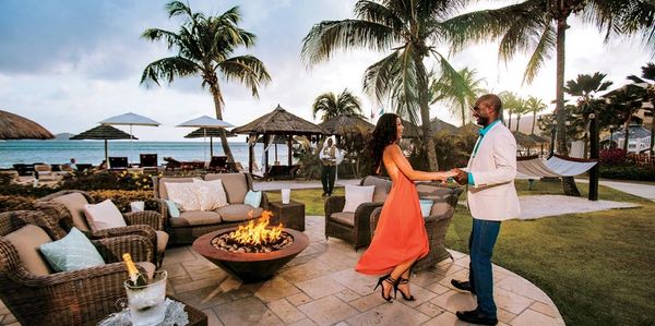 Couple dances by a fire pit