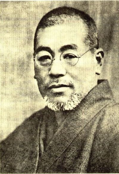 Vintage portrait of an elderly man with glasses and a beard.