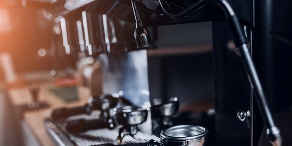 Close-up of a commercial espresso machine with portafilters.